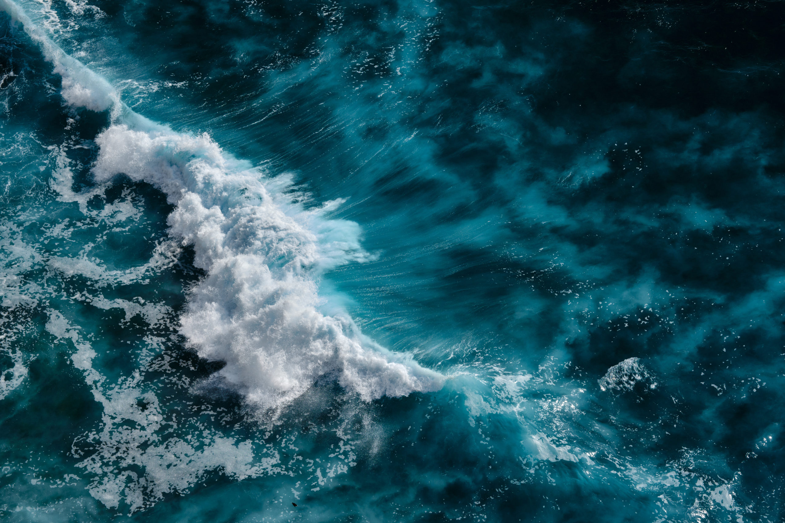 Aerial view to ocean waves. Blue water background
